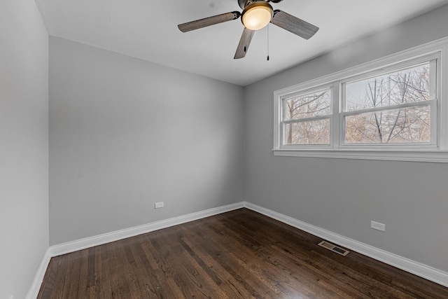 unfurnished bedroom with visible vents, baseboards, dark wood-type flooring, and a closet