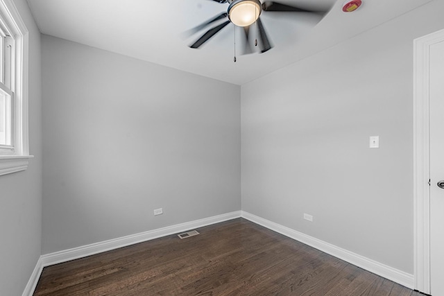 unfurnished bedroom featuring ceiling fan, baseboards, dark wood-type flooring, visible vents, and a closet