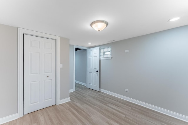 basement featuring baseboards and wood finished floors