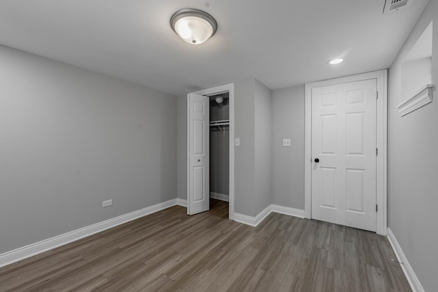 hall featuring baseboards and wood finished floors