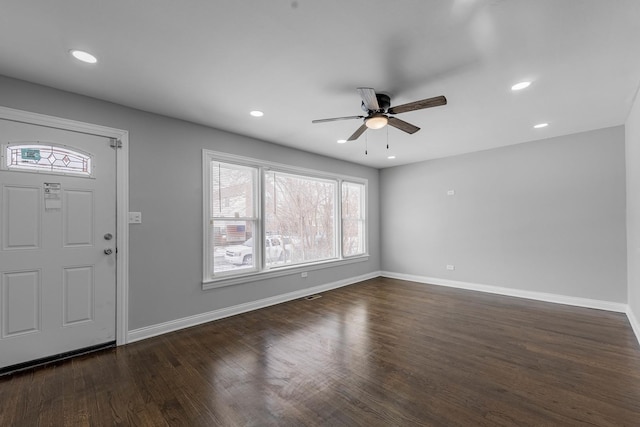unfurnished living room with baseboards, ceiling fan, and visible vents