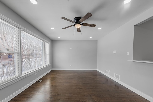 kitchen with white cabinets, dark wood-style flooring, appliances with stainless steel finishes, tasteful backsplash, and visible vents