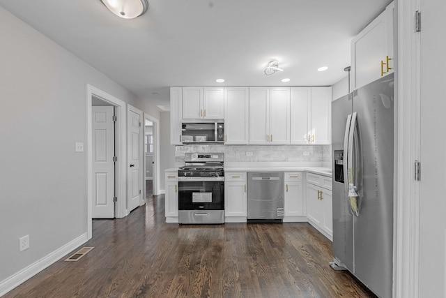 kitchen with light countertops, stainless steel appliances, white cabinets, and a sink