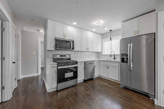 kitchen featuring stainless steel fridge, a sink, dark wood finished floors, a ceiling fan, and baseboards