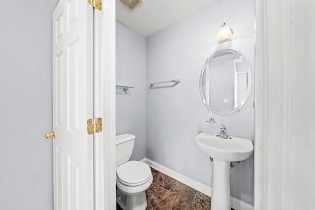 bathroom with toilet, baseboards, and visible vents