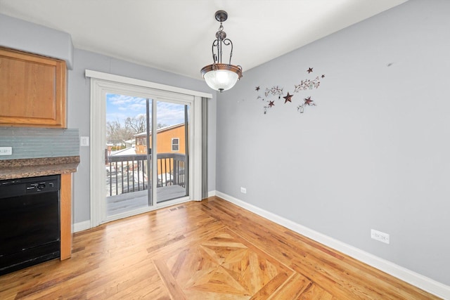 unfurnished dining area with parquet floors, visible vents, and baseboards