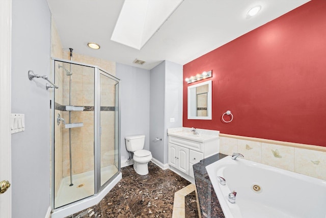 bathroom featuring a skylight, visible vents, toilet, a jetted tub, and vanity