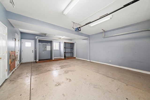 garage with baseboards and a garage door opener