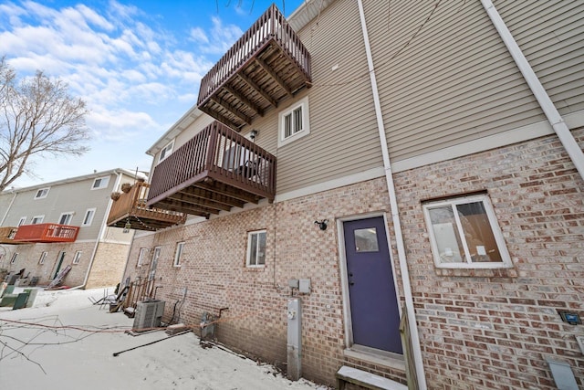 view of home's exterior with brick siding and cooling unit