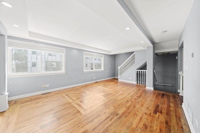 unfurnished living room with visible vents, stairs, baseboards, and recessed lighting