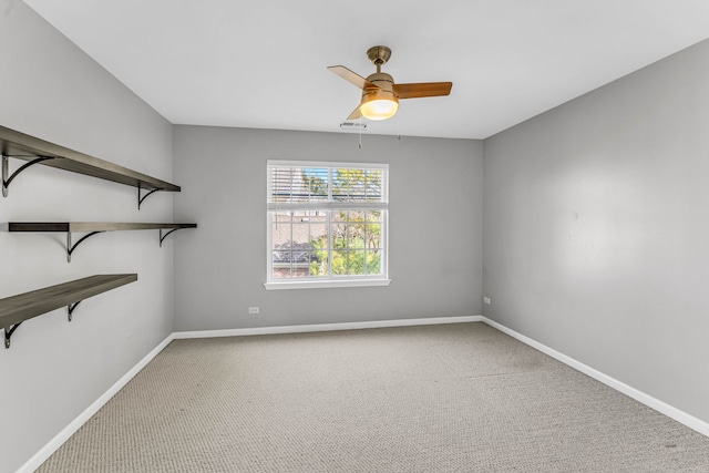 spare room with ceiling fan, baseboards, and carpet floors