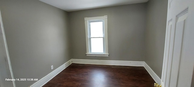 unfurnished room with dark wood-style floors and baseboards