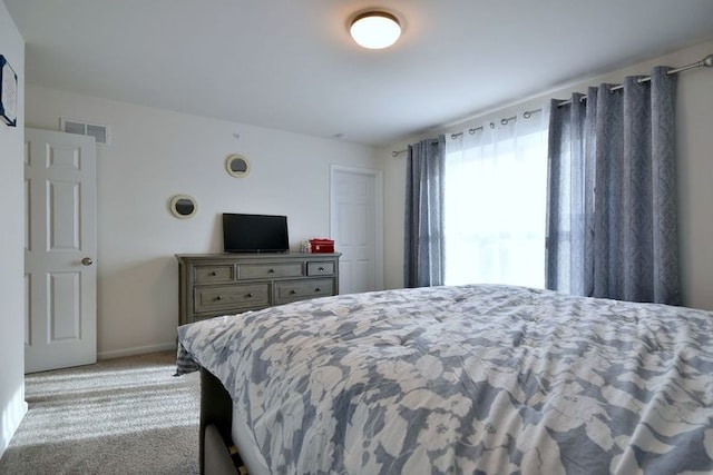 bedroom featuring carpet floors, visible vents, and baseboards