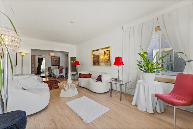 living room with a chandelier and hardwood / wood-style floors