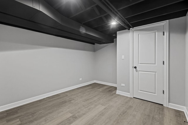 finished basement featuring baseboards and wood finished floors