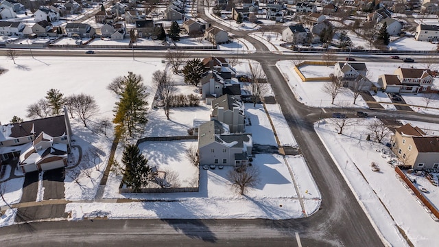 snowy aerial view with a residential view