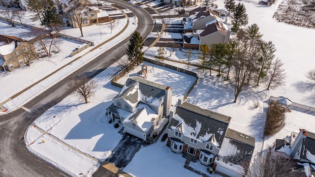 snowy aerial view featuring a residential view