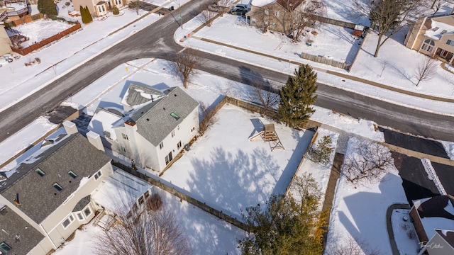 snowy aerial view featuring a residential view