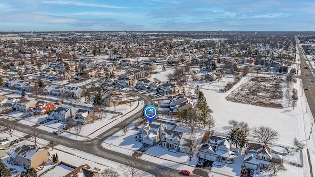 snowy aerial view with a residential view