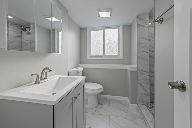 full bathroom with marble finish floor, walk in shower, vanity, and baseboards