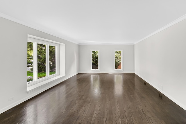 unfurnished room with crown molding, dark wood-style flooring, and baseboards