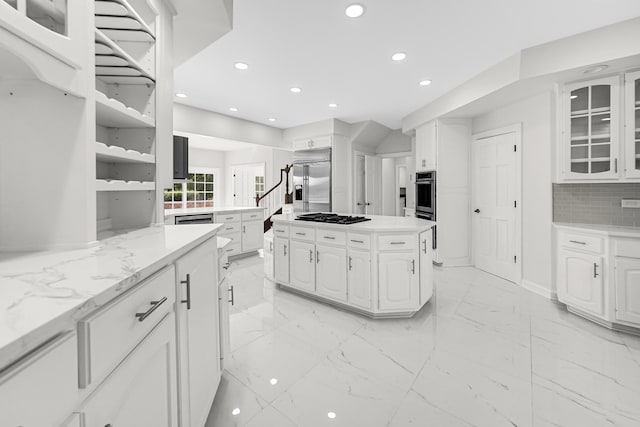 kitchen with stainless steel appliances, marble finish floor, white cabinets, and glass insert cabinets