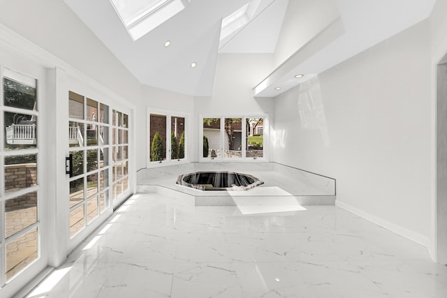 interior space with vaulted ceiling with skylight