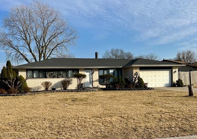 ranch-style house with a front yard, brick siding, and a garage