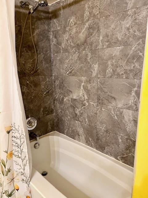 bathroom with shower / bath combination with curtain