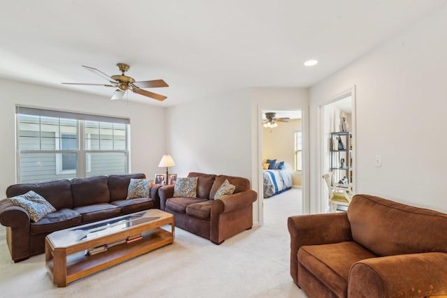 living room featuring light carpet, ceiling fan, and recessed lighting