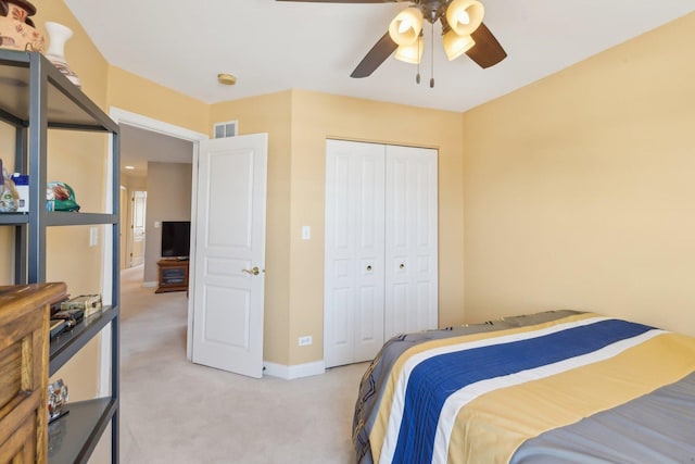 bedroom with light carpet, baseboards, visible vents, ceiling fan, and a closet