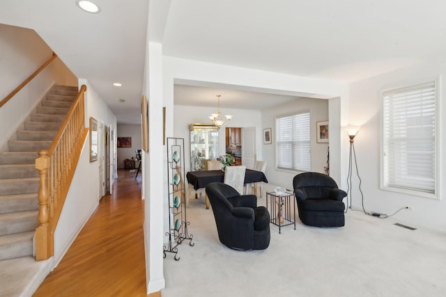 interior space featuring visible vents, stairway, an inviting chandelier, carpet flooring, and recessed lighting