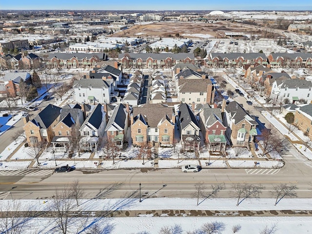 snowy aerial view with a residential view