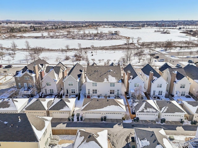 snowy aerial view featuring a residential view