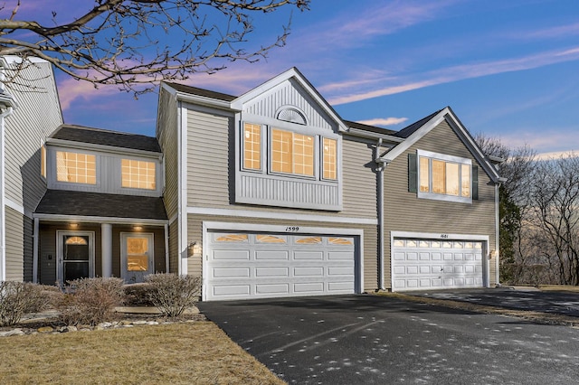 traditional-style house featuring driveway and an attached garage