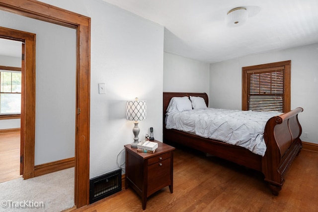 bedroom featuring baseboards and wood finished floors