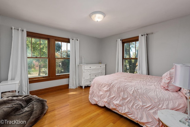 bedroom with wood finished floors and baseboards