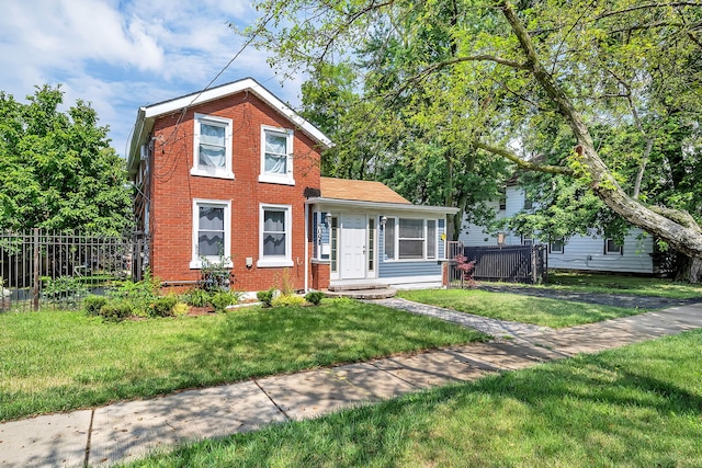 traditional-style home featuring brick siding, fence, and a front lawn