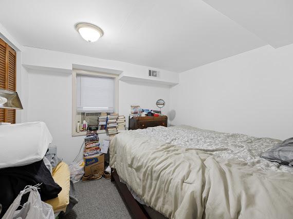 bedroom featuring carpet floors and visible vents