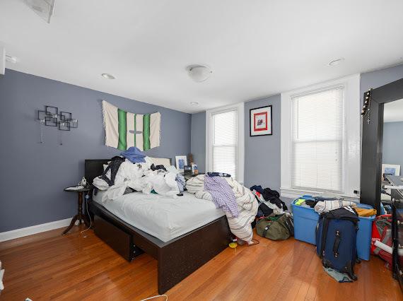 bedroom featuring baseboards and wood finished floors