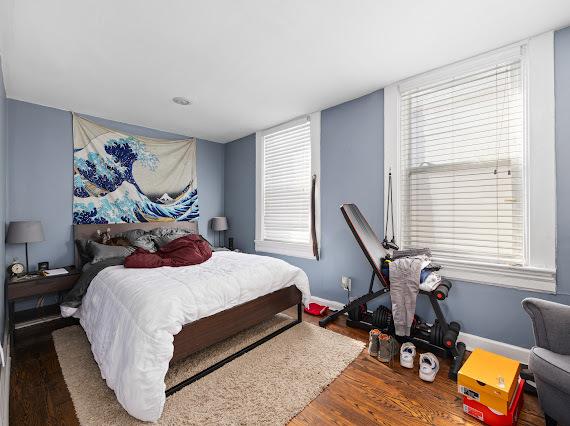 bedroom featuring baseboards and wood finished floors