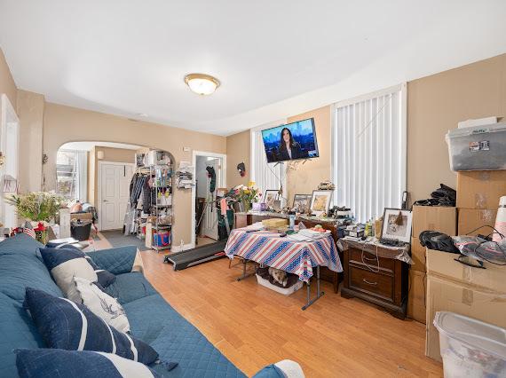 bedroom featuring light wood-style flooring and arched walkways