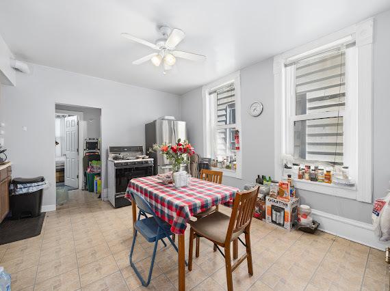 dining area featuring baseboards and a ceiling fan