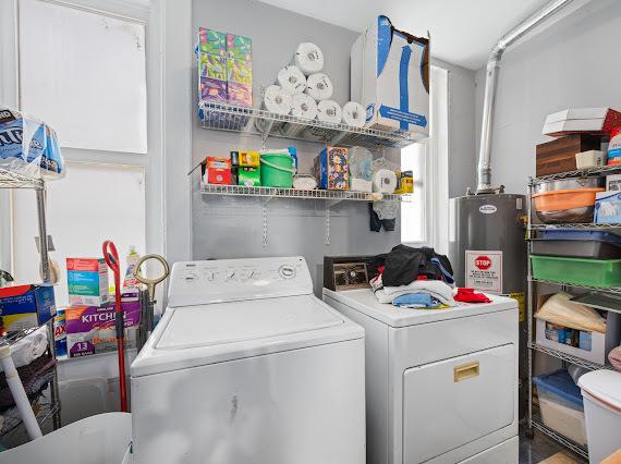 laundry room with laundry area, washer and clothes dryer, and gas water heater