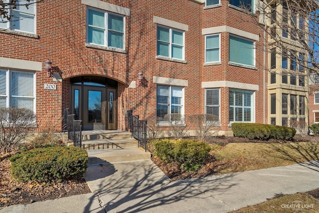 doorway to property with brick siding