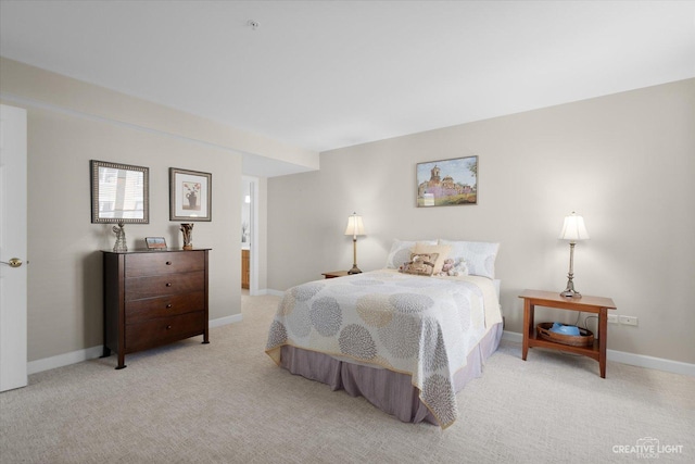 bedroom with baseboards and light colored carpet