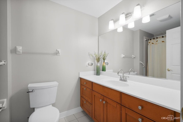 bathroom with tile patterned flooring, toilet, vanity, visible vents, and baseboards