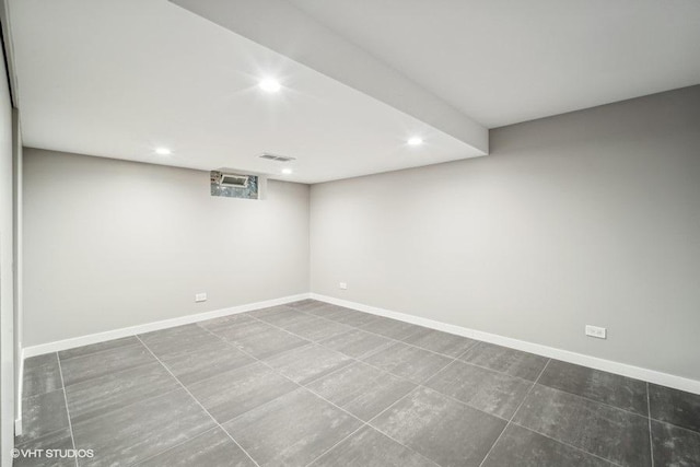 finished below grade area featuring recessed lighting, visible vents, and baseboards