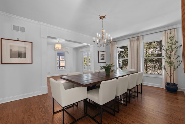 dining space with baseboards, visible vents, dark wood finished floors, ornamental molding, and an inviting chandelier
