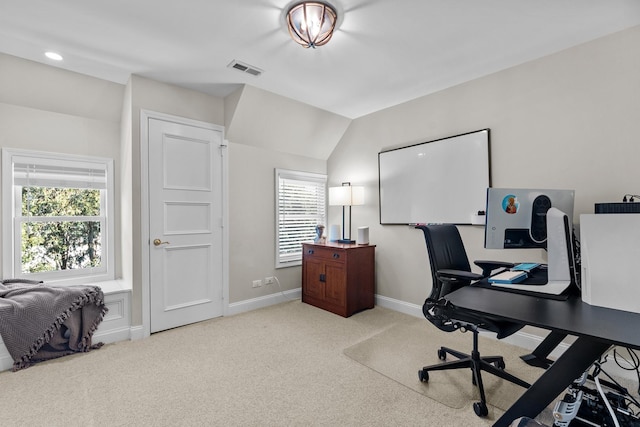 carpeted office with baseboards, visible vents, and a healthy amount of sunlight